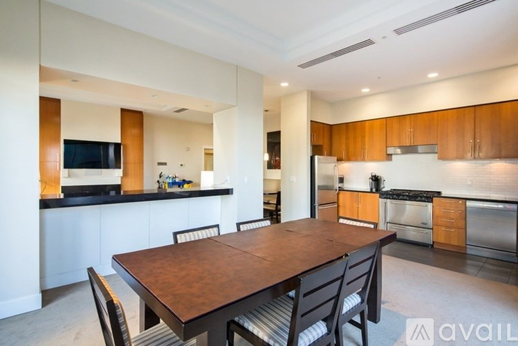 A modern kitchen with a wooden dining table and chairs.