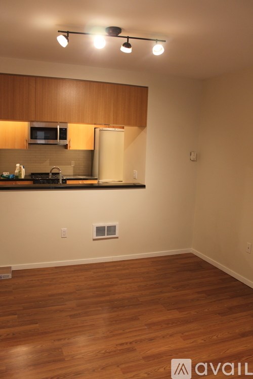 A kitchen with wooden cabinets and a white refrigerator.