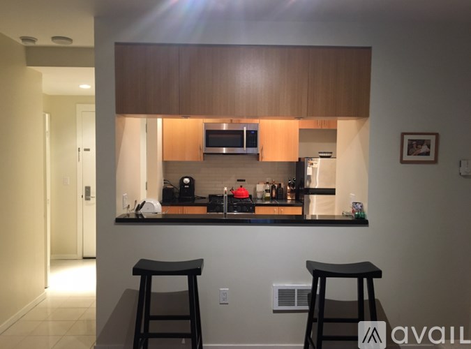A kitchen with a bar stool in front of it.