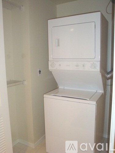 A white dishwasher is in a small kitchen.