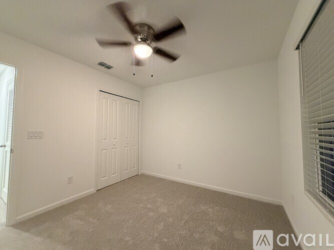 A white toilet in a bathroom with a glass shower door.