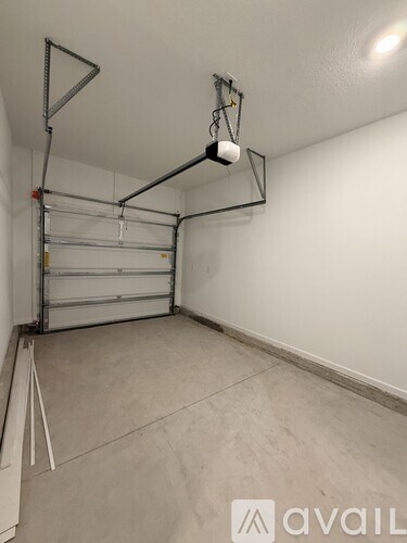 A room with a carpeted floor and a door on the right side.