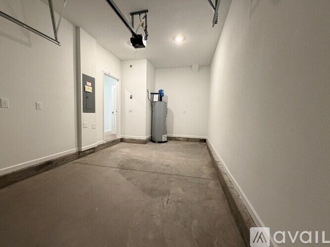 A room with a white wall and a door in the background.