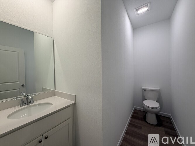 A white kitchen countertop with a sink and a faucet.