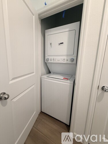 A white washing machine and dryer in a small laundry room.
