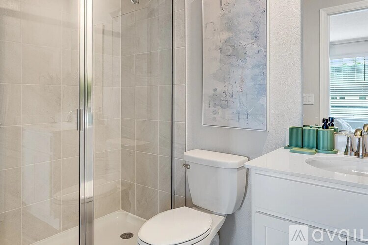 A white toilet in a bathroom with a glass shower door.