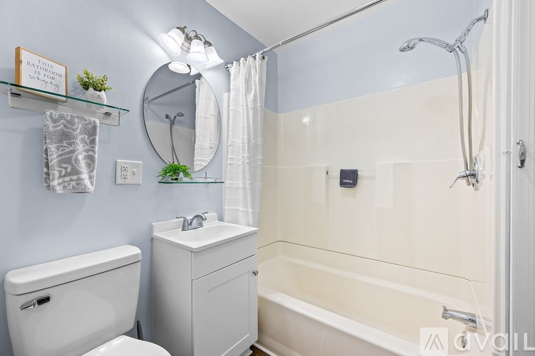 A room with a ceiling fan and a chair with a yellow throw.
