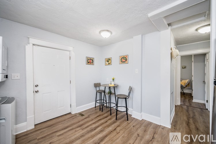 A small dining area with a table and chairs.