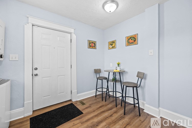 A bedroom with a white bed and a ceiling fan.