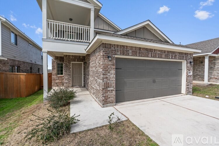 A house with a garage and a balcony is for sale.