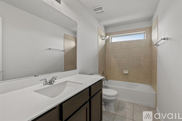 A bathroom with a white sink, toilet, and bathtub.