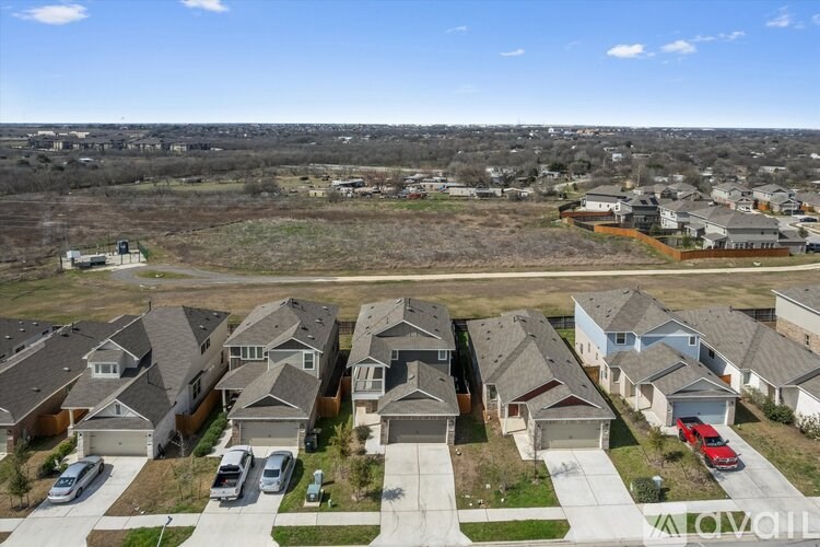 A suburban neighborhood with houses and cars parked in front.