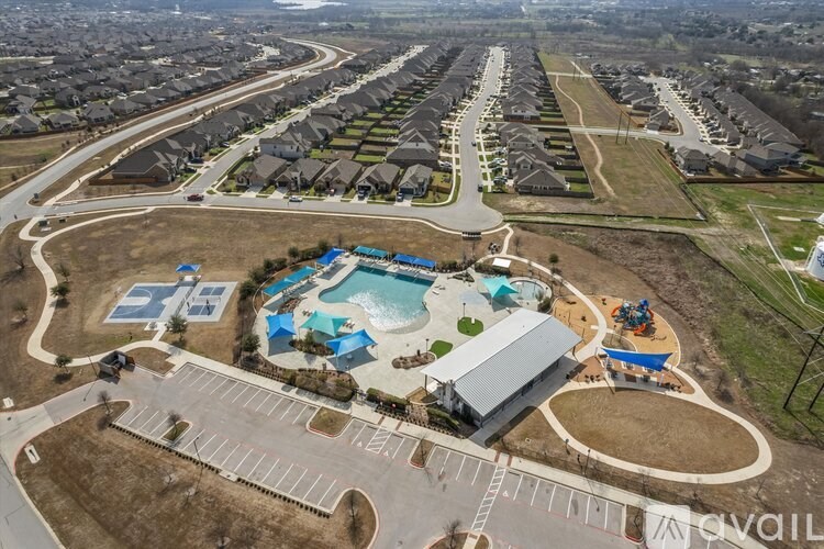 A bird's eye view of a residential area with a swimming pool and a playground.