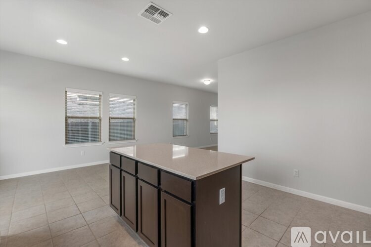 A spacious room with a counter and cabinets.
