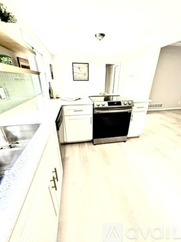 A kitchen with a white oven and a white fridge.
