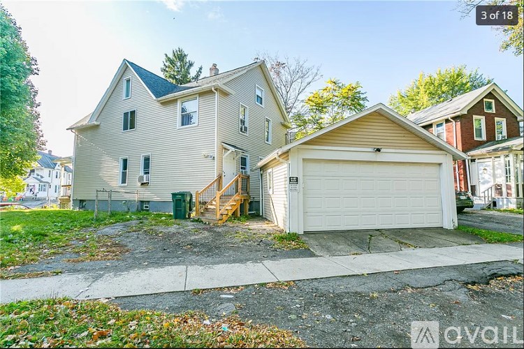 A two-story house with a garage is for sale.