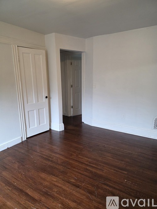 A room with a white door and a white wall.