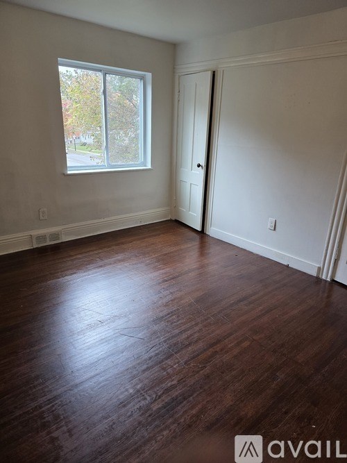 A room with wooden floors and a window.