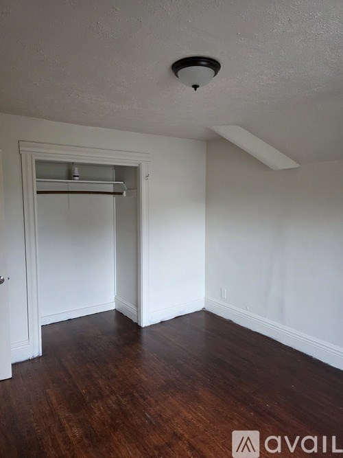A room with a white ceiling and wooden floor.