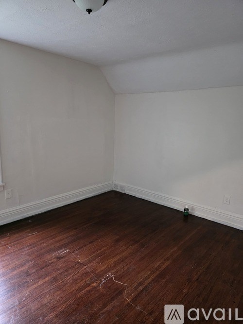 A room with wooden floors and white walls.