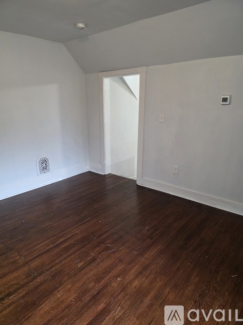 A room with wooden floors and white walls.