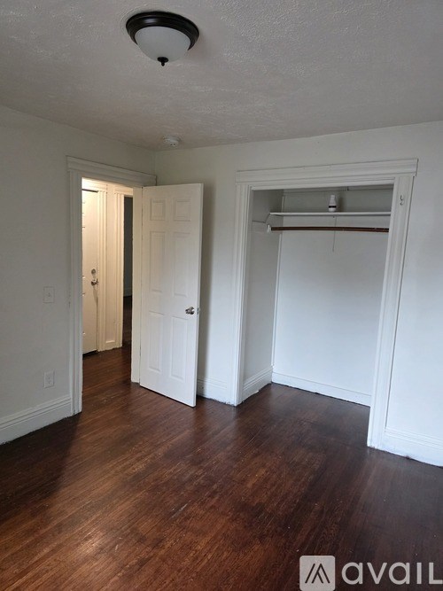 A room with white walls and a wooden floor.