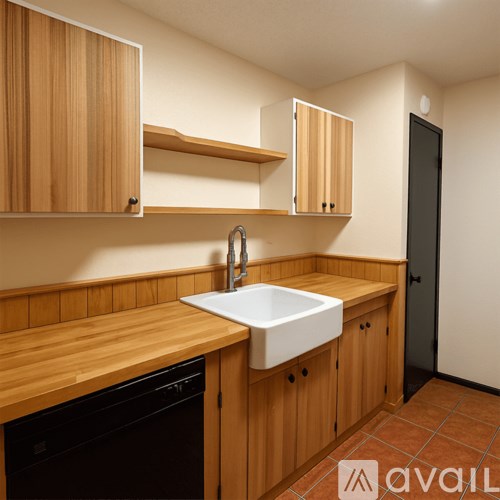 A kitchen with wooden cabinets and a white sink.