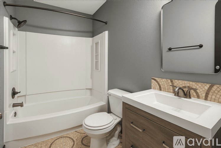 A bathroom with a toilet, sink, and bathtub.