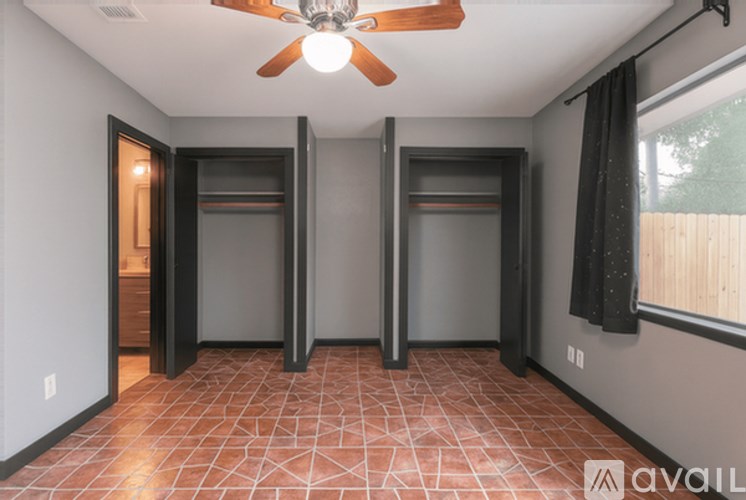 A room with a ceiling fan and tile flooring.