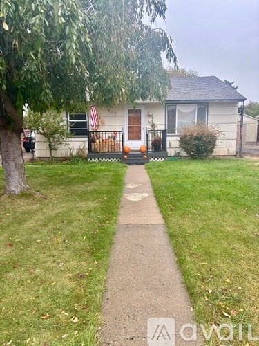 A white house with a flag on the front porch.