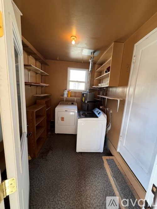 A small laundry room with a washer and dryer.