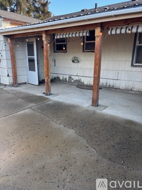 A house with a white exterior and a porch with a wooden column.
