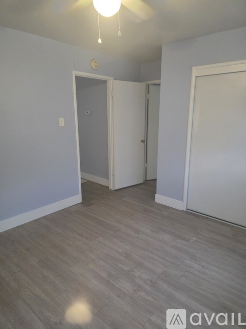 A room with a grey floor and white walls.