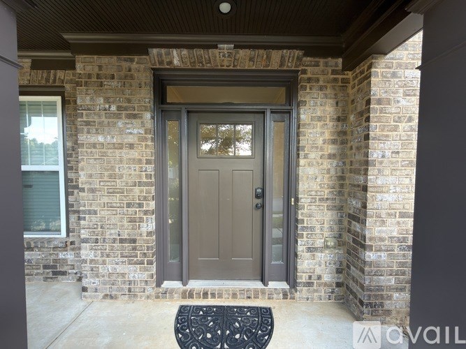 A grey door is on a brick building.