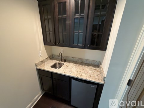 A kitchen with a sink and cabinets.