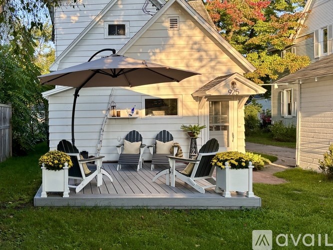 A patio with a table and chairs under an umbrella.