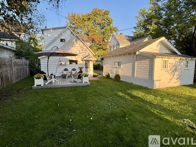 A backyard with a patio and a house.