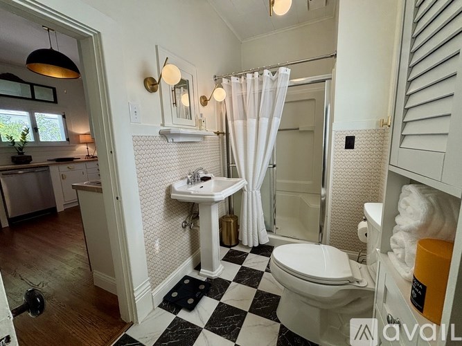 A bathroom with a black and white checkered floor.