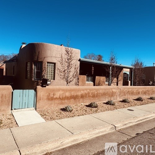 A house with a blue door and a brown stucco exterior.