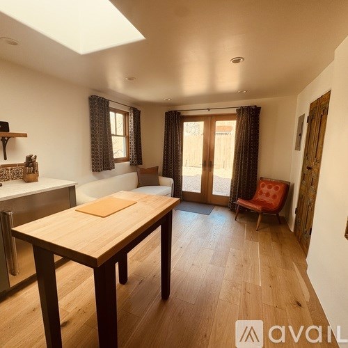 A dining room with a wooden table and chairs.