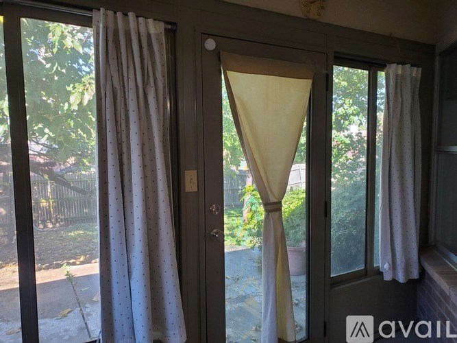 A window with a yellow curtain in the middle.