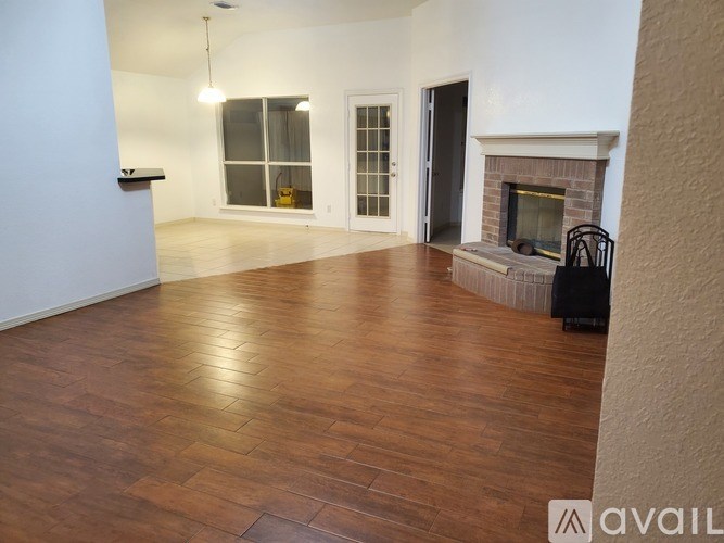 A living room with a fireplace and a chair.