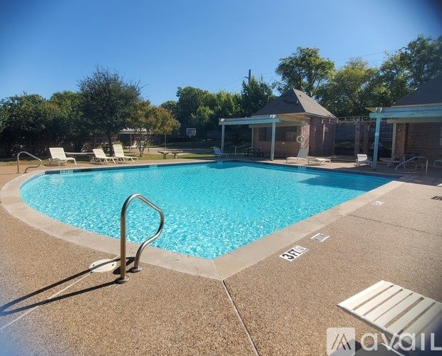 A pool with a ladder and a sun lounger.