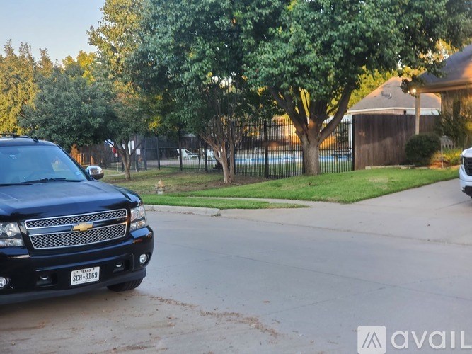 A black Chevrolet truck is parked on a street.