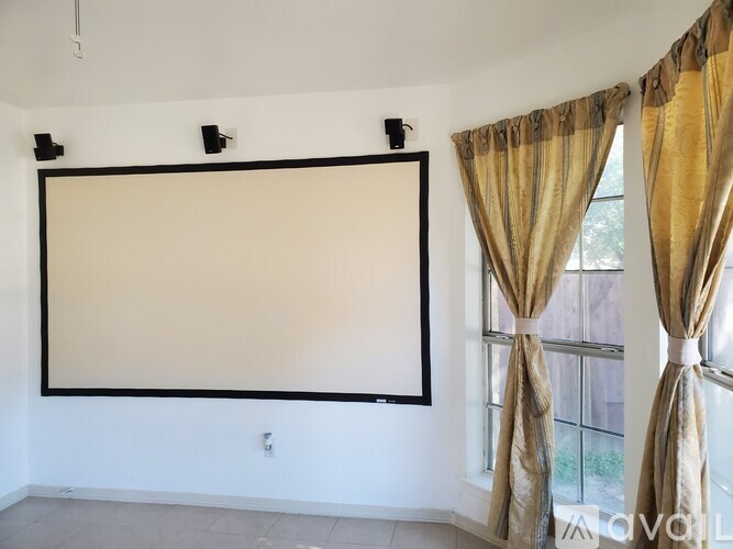 A room with a large whiteboard and curtains.