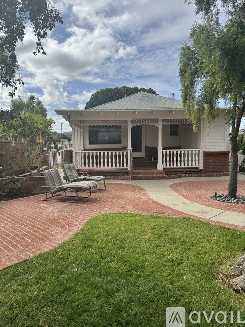 A house with a patio and a brick walkway.