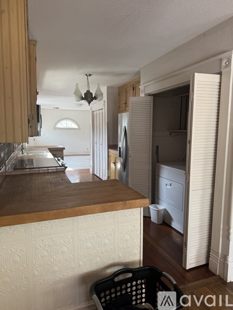 A kitchen with a counter and a dishwasher.