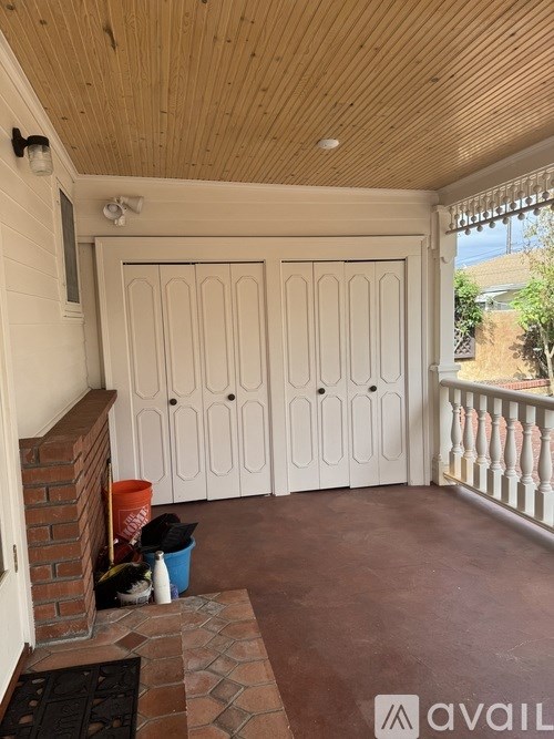A room with a wooden ceiling and a white door.