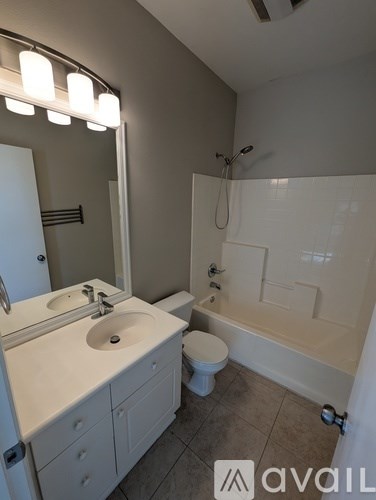 A bathroom with a sink, toilet, and bathtub.