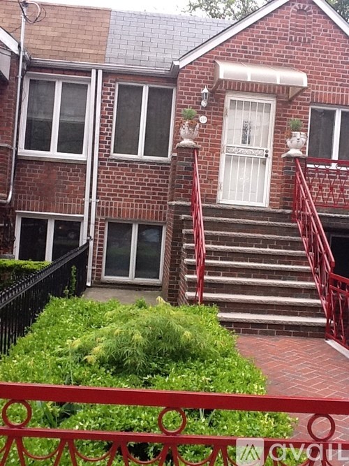 A red brick house with a white door and windows.